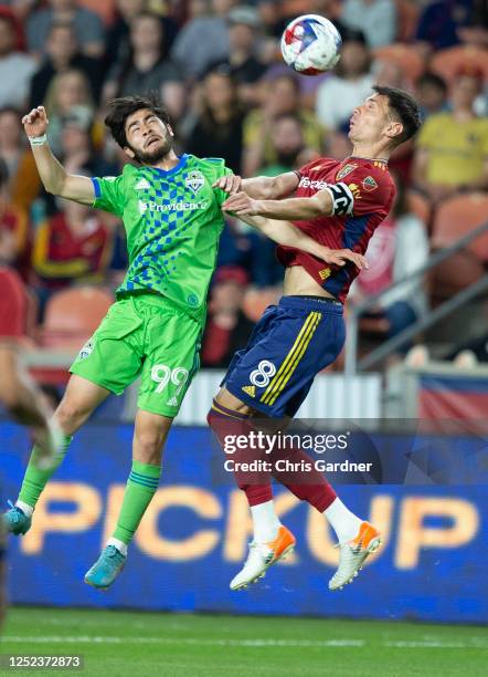 Damir Kreilach of Real Salt Lake heads the ball away from Dylan Teves of the Seattle Sounders FC during the second half of their game at the America...