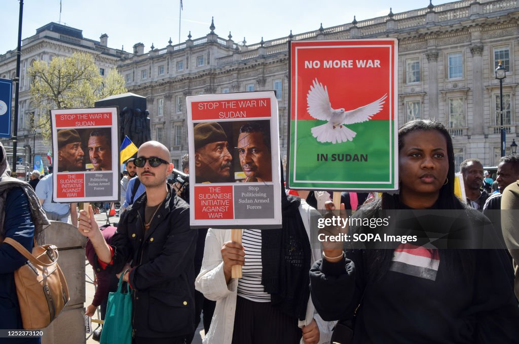 Protesters hold anti-war placards during the demonstration...