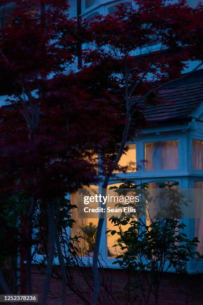 living room window at night - opening the curtains stock pictures, royalty-free photos & images