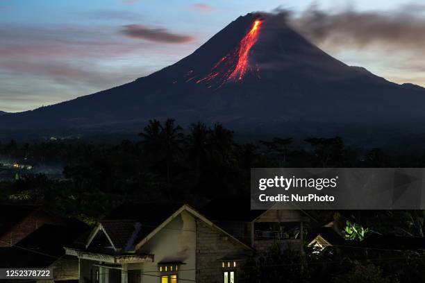 Mount Merapi, a volcanic mountain spews volcanic material as it erupts several times during sunrise from South Kaliurang village, Srumbung district...