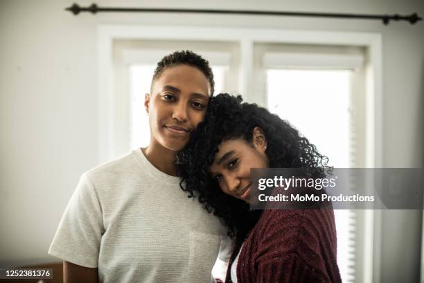 portrait of lesbian couple at home - head on shoulder stock pictures, royalty-free photos & images