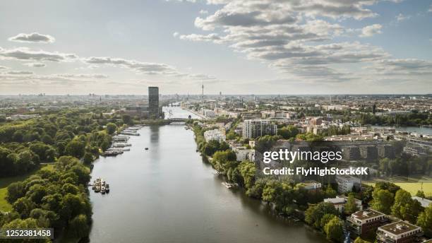 sunny, scenic view berlin cityscape and spree river, germany - park berlin stock-fotos und bilder