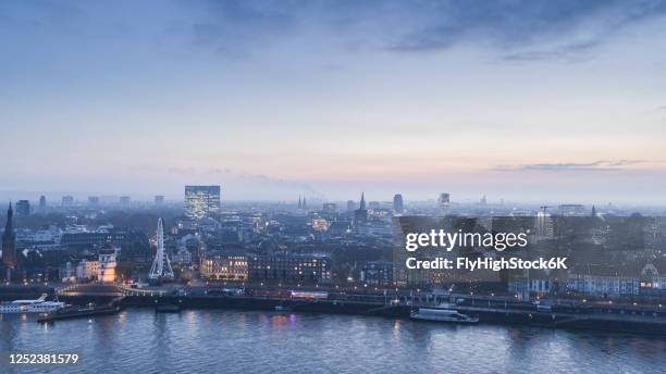 tranquil duesseldorf cityscape and rhine river at dusk, north rhine-westphalia, germany - düsseldorf skyline stock-fotos und bilder