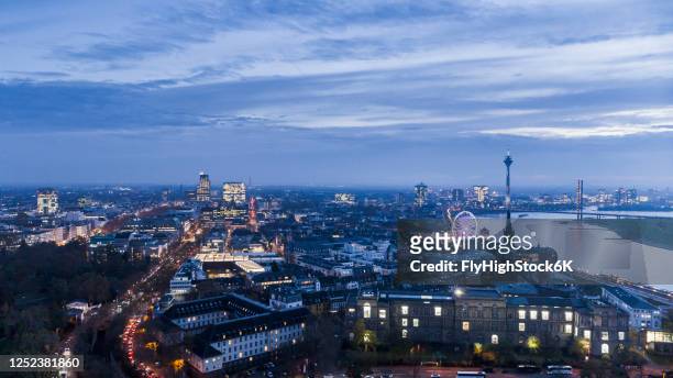 duesseldorf cityscape illuminated at dusk, north rhine-westphalia, germany - düsseldorf skyline stock-fotos und bilder
