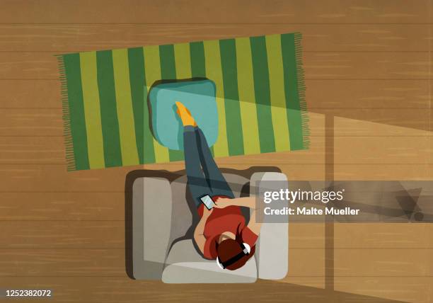 stockillustraties, clipart, cartoons en iconen met woman relaxing in armchair listening to music with headphones and smart phone - home decor