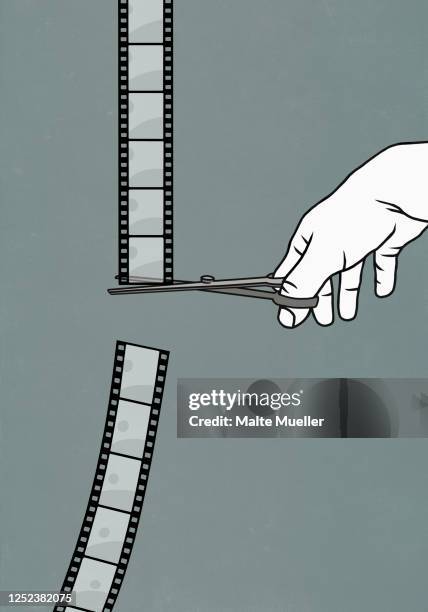 hand with scissors cutting film negative - photo editor stock-grafiken, -clipart, -cartoons und -symbole