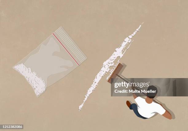 man sweeping up cocaine with broom - cocaine stock illustrations