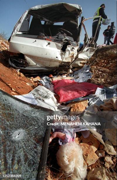 The shattered windshield and a doll lie at the site where Binyamin Zeev Kahane, son of the late Israeli extremist Rabbi Meir Kahane, and his wife,...