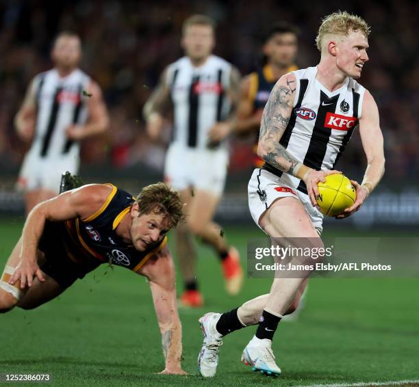 John Noble of the Magpies is tackled by Rory Sloane of the Crows during the 2023 AFL Round 07 match between the Adelaide Crows and the Collingwood...