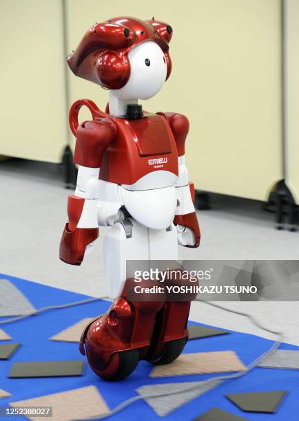 Japan's electronics giant Hitachi's humanoid robot "Emiew2", 80cm tall and weighing 14kg, demonstrates how it can move over uneven ground simulated...
