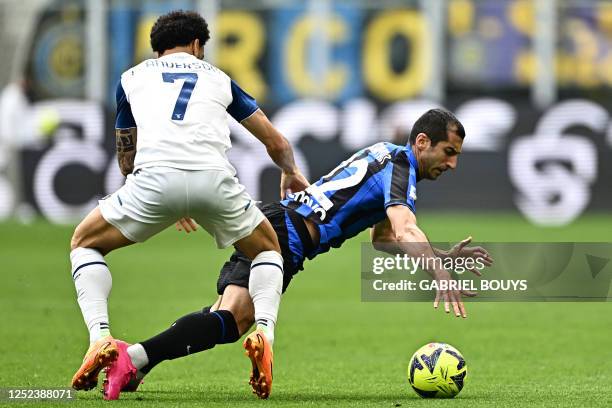 Inter Milan's Armenian midfielder Henrikh Mkhitaryan is tackled by Lazio's Brazilian forward Felipe Anderson during the Italian Serie A football...