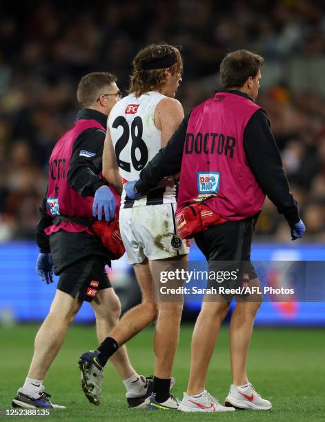 Nathan Murphy of the Magpies taken from the ground with suspected concussion during the 2023 AFL Round 07 match between the Adelaide Crows and the...