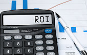 Word ROI on calculator. Business and tax concept. Stock photo