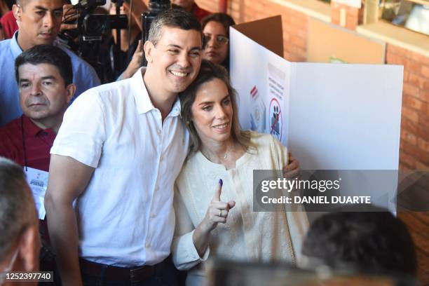 Paraguayan presidential candidate for the Colorado party, Santiago Peña, poses for a picture with his wife Leticia Ocampos de Peña after casting his...