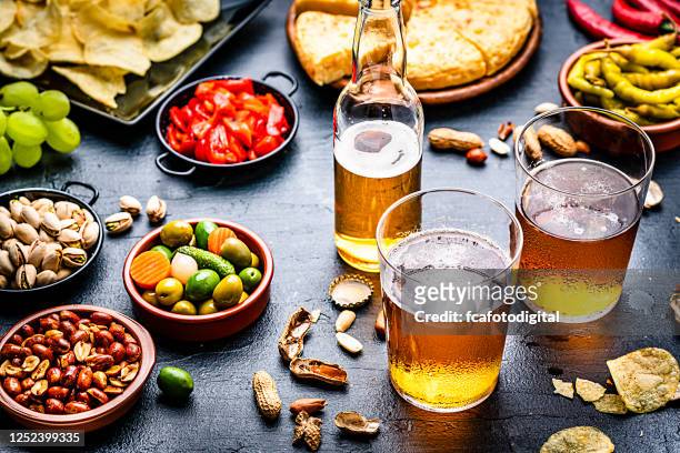 beer and tapas on bar counter - party food and drink stock pictures, royalty-free photos & images