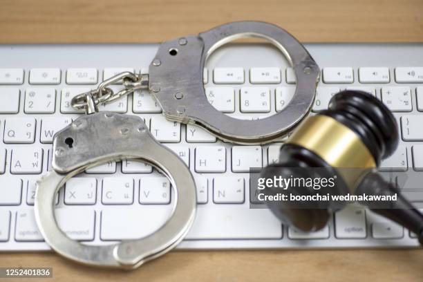 laptop, wooden gavel and handcuffs on light table, closeup. cyber crime - laptop ban stock pictures, royalty-free photos & images