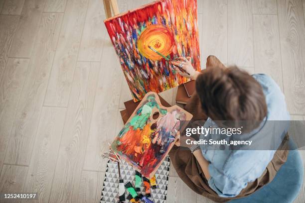 creative painter painting in her studio - fat women art stock pictures, royalty-free photos & images