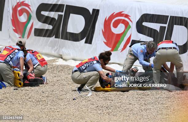 Rescuers tend to Yamaha French rider Fabio Quartararo and Aprilia Portuguese rider Miguel Oliveira after falling during the MotoGP Spanish Grand Prix...