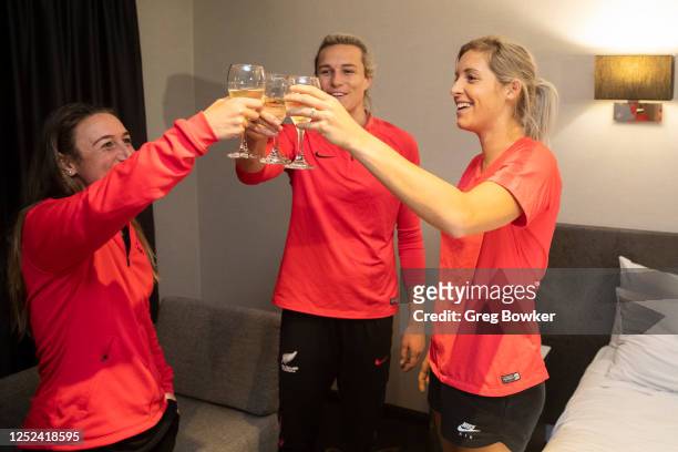 Annalie Longo, Hannah Wilkinson and Erin Nayler celebrate with wine after the FIFA announcement that Australia and New Zealand have been successful...