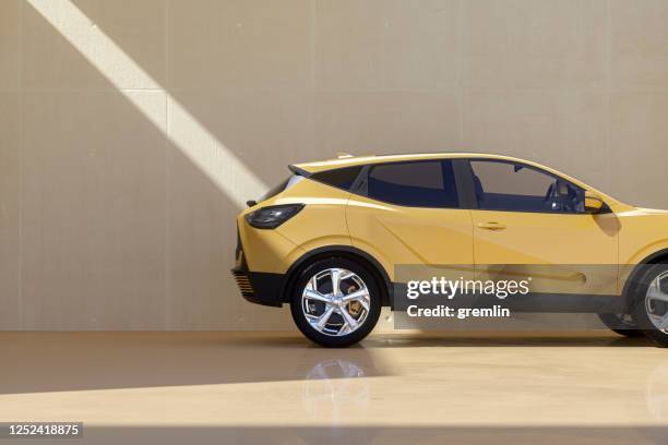 generic modern car against concrete wall - yellow car stock pictures, royalty-free photos & images