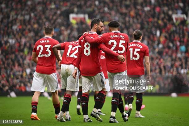 Manchester United's Portuguese midfielder Bruno Fernandes celebrates with Manchester United's English striker Jadon Sancho after scoring his team...