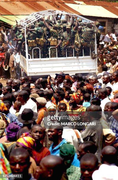 Truck, part of a column of trucks loaded with some 2,000 soldiers of the Rwandan Patriotic Army, drives 01 October 2002 through the center of Bikavu,...