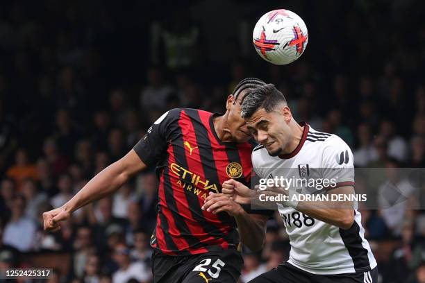 Manchester City's Swiss defender Manuel Akanji and Fulham's Brazilian midfielder Andreas Pereira clash heads during the English Premier League...