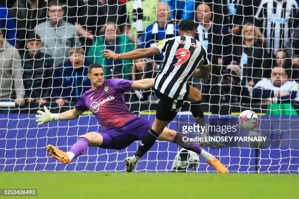 Newcastle United's English striker Callum Wilson shoots and scores a goal that will be disallowed due to an o during the English Premier League...