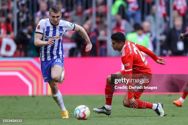 Jonjoe Kenny of Hertha BSC and Joao Cancelo of Bayern Muenchen battle for the ball during the Bundesliga match between FC Bayern München and Hertha...
