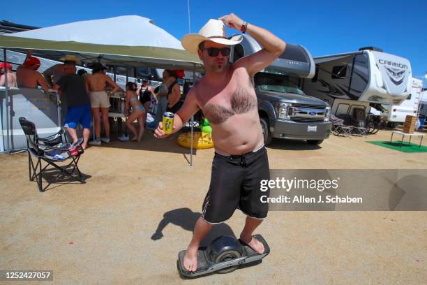 With his body hair shaved like a bra, Berk Cakmak, of Rancho Santa Margarita,rides a one-wheel through the campground The Resort at Stagecoach...