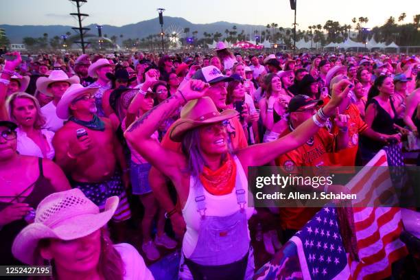 Crowds watch Gabby Barrett perform with her husband guitarist Cade Foehner on the Mane Stage at Stagecoach Country Music Festival at the Empire Polo...