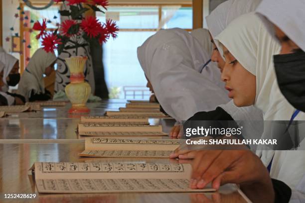 Afghan girls attend their class at a primary school in Jalalabad on April 30, 2023.