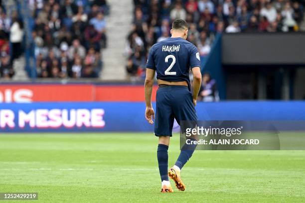 Paris Saint-Germain's Moroccan defender Achraf Hakimi reacts after receiving a second yellow card resulting in his being sent off during the French...