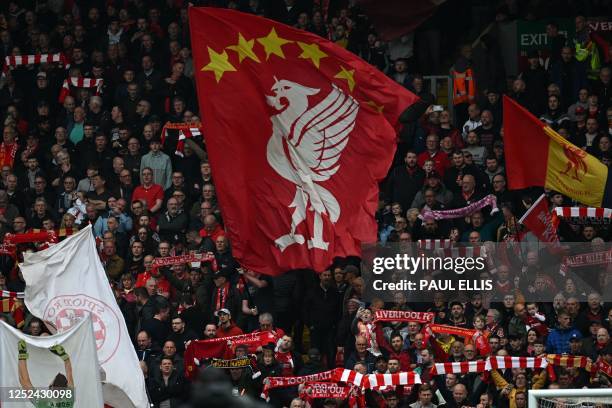 Liverpool fans waves their flags ahead of kick off in the English Premier League football match between Liverpool and Tottenham Hotspur at Anfield in...