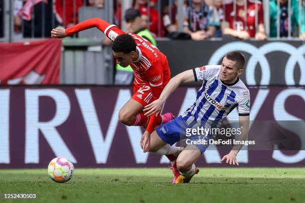Jamal Musiala of Bayern Muenchen and Jonjoe Kenny of Hertha BSC battle for the ball during the Bundesliga match between FC Bayern München and Hertha...