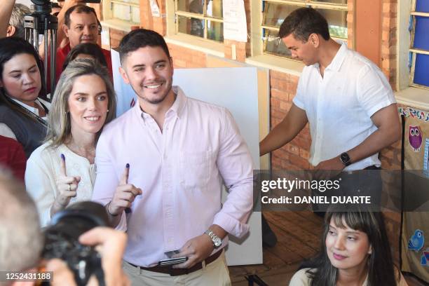 Paraguayan presidential candidate for the Colorado party, Santiago Peña , casts his vote while his wife Leticia Ocampos de Peña and his son show...