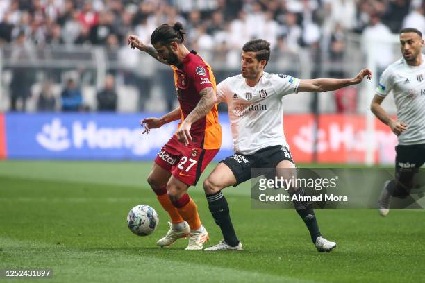 Sergio Oliveira of Galatasaray is challenged by Salih Ucan of Besiktas during the Super Lig match between Besiktas and Galatasaray at Vodafone Park...