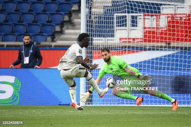 Lorient's Senegalese forward Bamba Dieng kicks to score his team's third goal during the French L1 football match between Paris Saint-Germain and FC...