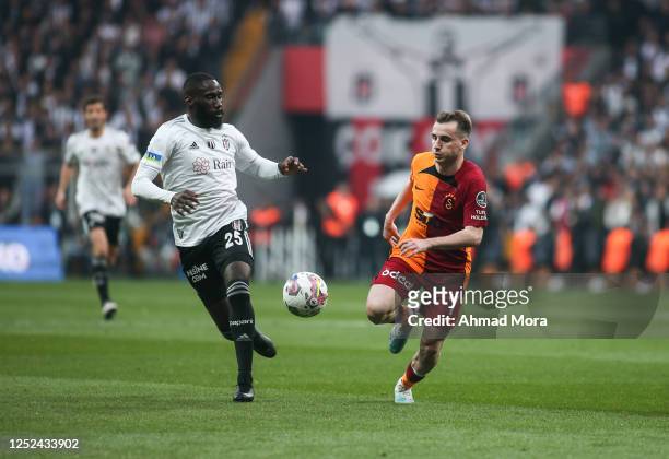 Kerem Kerem Akturoglu of Galatasaray is challenged by Arthur Masuaku of Besiktas during the Super Lig match between Besiktas and Galatasaray at...