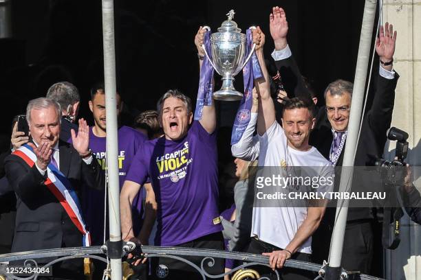 Toulouse's French head coach Philippe Montanier and Toulouse's Belgian midfielder Brecht Dejaegere , stand on a balcony of the Capitole next to Mayor...