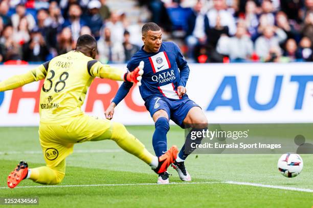 Kylian Mbappe of Paris Saint Germain plays against Goalkeeper Yvon Mvogo of Lorient during the Ligue 1 match between Paris Saint-Germain and FC...