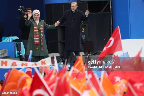 Turkish President and People's Alliance's presidential candidate Recep Tayyip Erdogan and his wife Emine Erdogan wave to supporters during an...