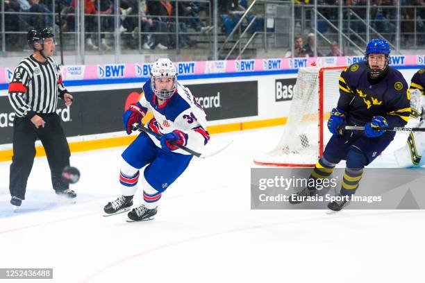 Cole Eiserman of United States and Axel Hurtig of Sweden chasing the puck during final of U18 Ice Hockey World Championship match between United...