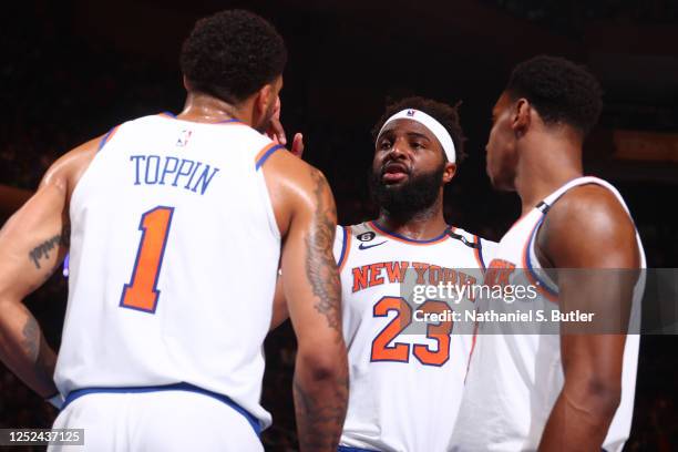 Mitchell Robinson speaks with Obi Toppin and RJ Barrett of the New York Knicks during Game 1 of the Eastern Conference Semi-Finals of the 2023 NBA...