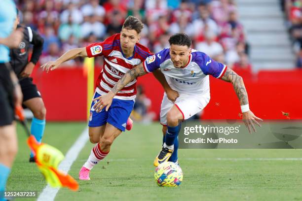 Bryan Zaragoza, of Granada CF and Jose Rios Reina, of SD Eibar during the La Liga Smartbank match between Granada CF and SD Eibar at Nuevo Los...