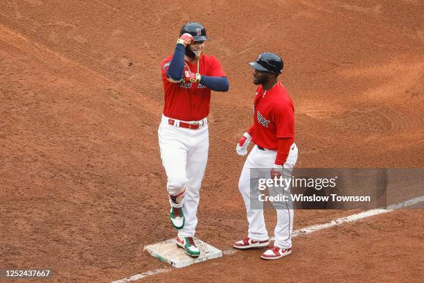 Alex Verdugo of the Boston Red Sox makes a muscles towards the dugout after his two-run single against the Cleveland Guardians during the fifth...