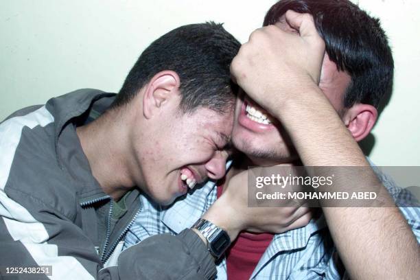 Relatives mourn during the funeral of 15-year-old Palestinian Alaa Sghedi in the southern Gaza border town of Rafah 19 December 2002. The teenager...