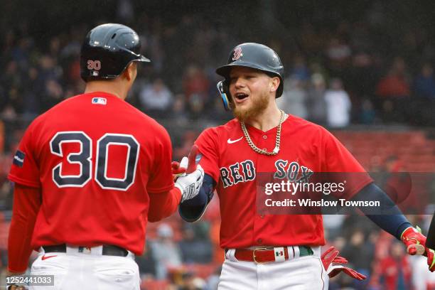 Alex Verdugo of the Boston Red Sox is congratulated by Rob Refsnyder after his home run against the Cleveland Guardians during the seventh inning at...