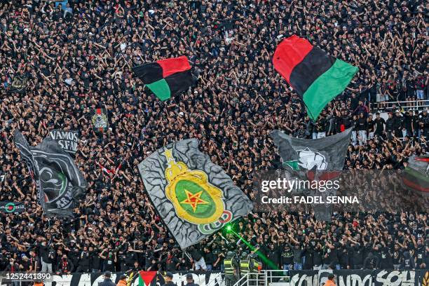 Supporters of AS FAR react during the CAF Confederation Cup quarter-final football match between Morocco's AS FAR and Algeria's USM Alger at the...