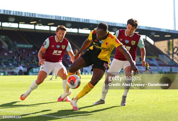 Danny Welbeck of Watford FC holds off Matthew Lowton and James Tarkowski of Burnley FC during the Premier League match between Burnley FC and Watford...
